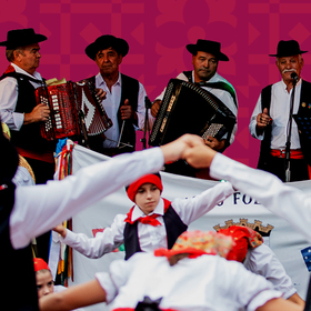 Band playing with concertina instruments and people dancing